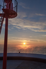 Banjo Pier at sunrise with seaming sea at Looe Cornwall, entrance to harbour navigation lights