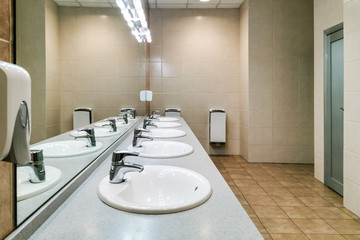 Modern sinks with mirror in public toilet
