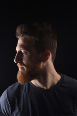 portrait of profile of a serious man on black background