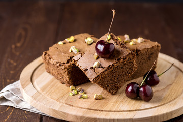 Tasty Homemade Dessert Chocolate Brownie Decorated with Berry and Nuts on Wooden Tray Homemade Dessert Horizontal