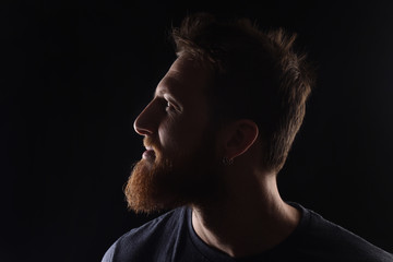 portrait of profile of a man on black background