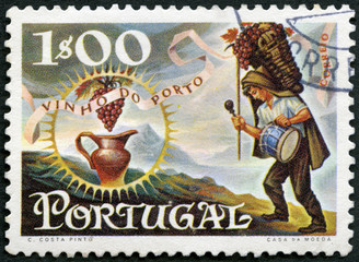 PORTUGAL - 1970: shows Worker carrying basket of grapes and jug, series Publicity for port wine export