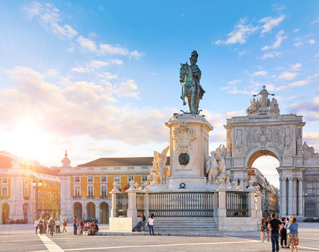 Lisbon, Portugal. King Jose I Statue at Praca do Comercio in front of Triumphal Arch near waterfront. Old town of Lisboa in historic midtown Alfama district. Evening sunset and blue sky with clouds.