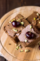 Tasty Homemade Dessert Chocolate Brownie Decorated with Berry and Nuts on Wooden Tray Homemade Dessert Vertical Above