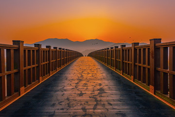Wooden bridge Sunrise landscape at Suncheon bay Korea.