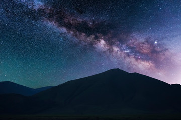 Beautiful starry sky. Milky way galaxy over the mountains. Night landscape.