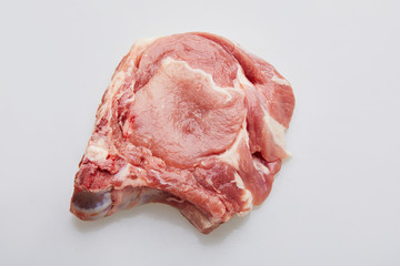 Raw pork loin isolated on white background. Raw fresh pork fillet steak with the bone. Sliced raw pork meat isolated. 