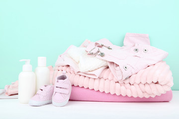 Baby clothes with bottles on blue background