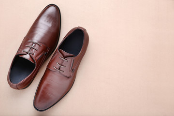 Male leather shoes on beige background