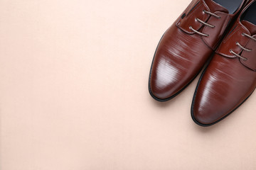 Male leather shoes on beige background