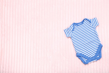 Baby clothes on pink background