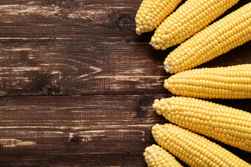 Ripe corn on brown wooden table