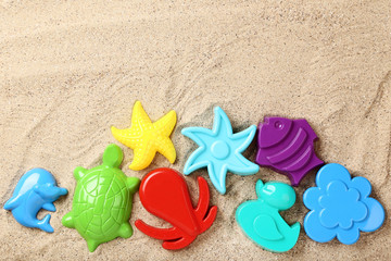 Fototapeta na wymiar Colorful plastic toys on beach sand