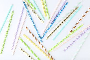 Colorful paper straws on white background