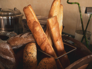 assortment of baked breads, french baguette on wood box