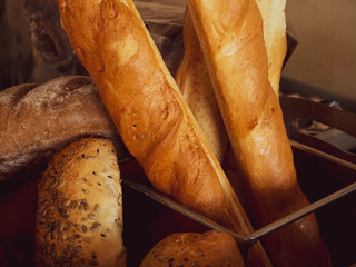 assortment of baked breads, french baguette on wood box