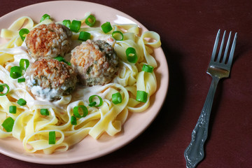 Pasta with meatballs on a dark background