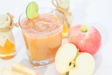 blended fresh apple juice smoothie and honey bee and lemon.Beverage healthy the taste in glass on white wooden