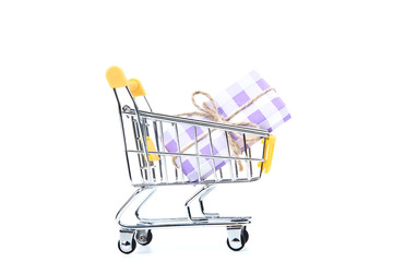 Small shopping cart with gift box isolated on white background