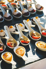 Salad and light meals, canapes on the table in the restaurant.