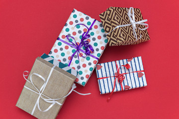 Holiday gift boxes, presents isolated on red background.
