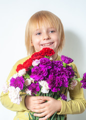 happy little boy and a bunch of flowers