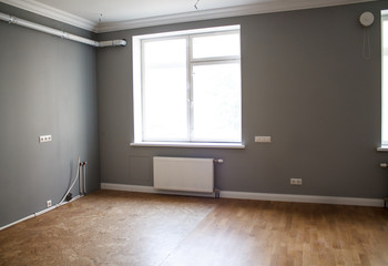 the interior of the room after finishing the repair of the lilac walls without furniture