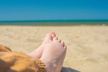 bare children's feet on the beach. close-up