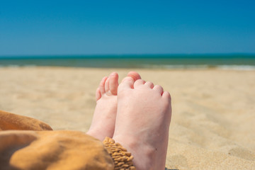 bare children's feet on the beach. close-up