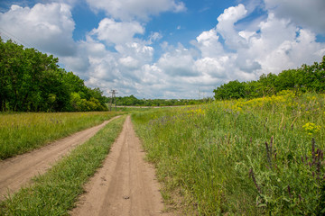 Summer landscape with railway and country road