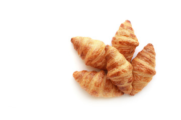 Five freshly baked tasty crusty croissants isolated on white.