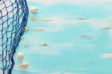 Top view of Fishnet on pastel blue wooden background. top view, flat lay