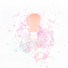 Сosmetic cream tube on pearl pastel confetti