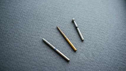 Dental bur tools close-up. Professional equipment for cleaning cavities on gray background.