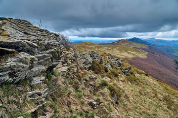 A beautiful panoramic mysterious view of the forest in the Bieszczady mountains (Poland) on a misty rainy spring May day, nature is lonely - without people