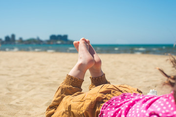 bare children's feet on the beach. close-up