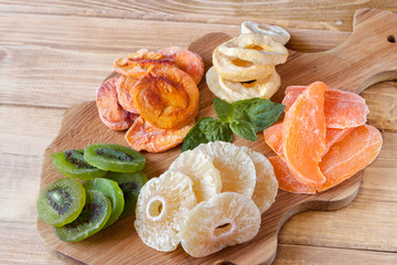 Mixed dried fruits on the wooden board.