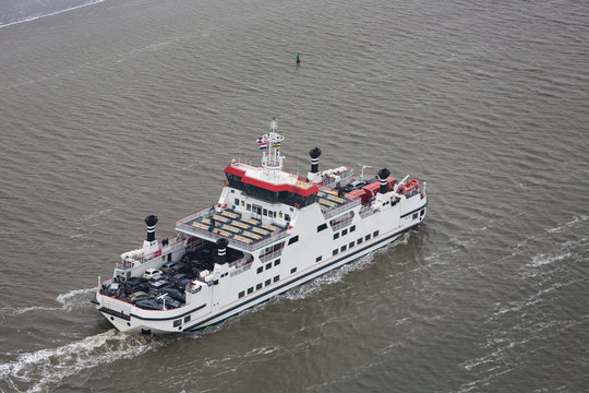 Dutch ferry boat at Wadden Sea navigating beween sandbanks