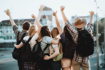 Friends traveling together. Cheerful students rising hands. People, sightseeing, vacation, holidays adventure friendship togetherness