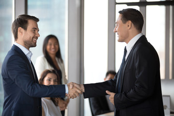 Fototapeta na wymiar Happy business partners handshake congratulating with deal closing
