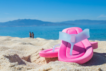 sandals in the sand of the beach