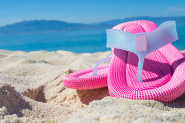 sandals in the sand of the beach