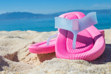 sandals in the sand of the beach