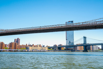 Under The Brooklyn Bridge, New York City. East River, Brooklyn Bridge and Manhattan Bridge. Boat Tour Journey