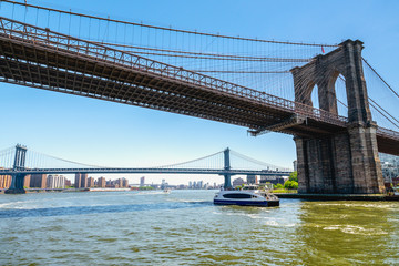 Under The Brooklyn Bridge, New York City. East River, Brooklyn Bridge and Manhattan Bridge. Boat Tour Journey