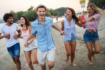 Multiracial group of friends enjoying a day at beach.