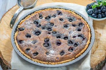 Blueberry and almond tart dusted with icing sugar
