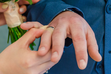 Just married young couple with bouquet of flowers