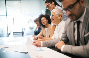 Group of successful business people at work in office