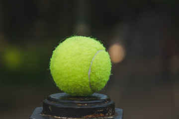 tennis ball lying on a metal stand